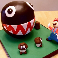 Chain Chomp Vs Mario For my husband's birthday. The chain chomp's bottom half is styrofoam, top half cake and the Gooma's and Mario is RKT.