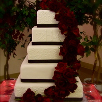 Kris Top 2 tiers are styrofoam and the bottom 3 are cake. The flowers are real, wired into a cascade and attached to the top styrofoam tier....