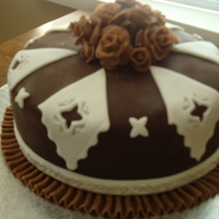 Chocolate Fondant Ruffles 9" round covered in chocolate fondant. Made the mistake of rolling it out on mat and then just flipping mat over onto cake. As you can...