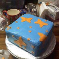 Butterflies Flying square cake with blue buttercream orange fondant butterflies with little flowers.