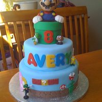 Super Mario Brothers Cake for my daughter's 8th birthday, Inspiration from debi1976 and JennS. Mario is RKT covered in modelling chocolate. Decorations are...