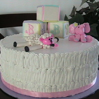 Baby Shower Cake This cake was is covered in whipped cream and the ribbon is not edible..It was my first try at making the gumpaste baby elephant and sheep...