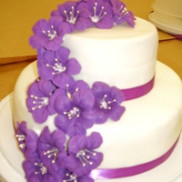 Purple Pansies I used fondant and royal icing flowers, with a silk ribbon. This was the final cake I did for wilton course 3.