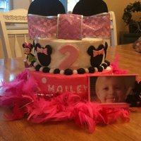 Minnie Mouse Cake 10" Vanilla and 8" chocolate, butter cream icing with fondant accents, feather boa, ribbon ffor the bow and cardboard for the big...