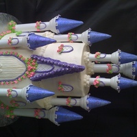 Princess Castle Castle cake is iced in buttercream with royal icing accents and disco dust on the turret tops. Used the Wilton Castle set. Each tier is 3...