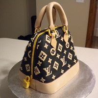 Louis Vuitton Purse Cake My first purse cake I made for my mother-in-law and sister-in-law's birthday. Carved then covered with fondant. Details in gumpaste...