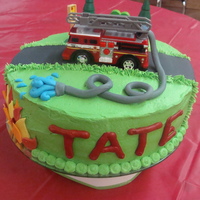 Fire Truck Cake This was a buttercream cake with fondant accents and a toy fire truck. Lots of fun to make!