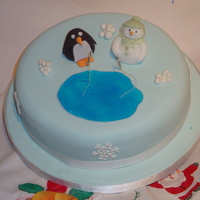 Snowman And Penguin Fishing This was made for my level 1 cake dec course. Rich fruit cake with marzipan and fondant. Water is made from piping gel coloured blue. TFL
