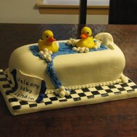 Rubber Ducky Bathtub Cake This was a cake for my husbands bosss' wife who was having a baby boy. The cake was carved then covered in fondant with hand made...