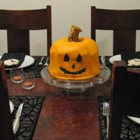 Jack-O-Lantern Cake Sculpted jack-o-lantern cake for a halloween party. Airbrushed orange and fondant steem.