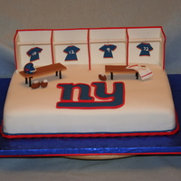 New York Giants Fan 9x13 cake covered with fondant. Made lockers, benches, Logo, football, helmet and jerseys out of tylose paste.