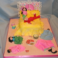 Slumber Party Cake Yellow cake covered with buttercream the fondant for the spread. The headboard was made of gumpaste. All figures were made of tylose paste...