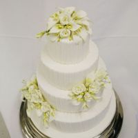 Fondant With Gumpaste Callas Cake covered with veritcal stripes of fondant. Gumpaste callas.