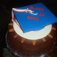 Graduation Cake German Chocolate Cake with coconut pecan filling. Covered in Chocolate Ganache and decorated with fondant graduation cap.