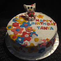 Hello Kitty Cake Chocolate cake with choc ganache filling, whipped cream frosting and fondant accents.