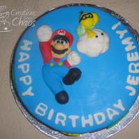 Super Mario Bros. Cake Super Mario cake for a friend's son's birthday. Cake is covered in fondant, all decor is fondant. Mario and Lakitu on top are...