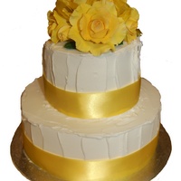 Rough Icing Wedding Cake With Yellow Roses This is a 2 tier chocolate wedding cake covered in rough royal icing and topped with yellow gum paste roses.
