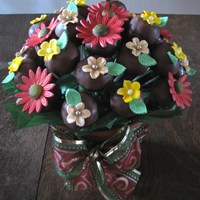 Christmas Cake Pop Bouquet I made these chocolate cake pops and added fondant flowers on them so I could make a bouquet.Thanks for looking.