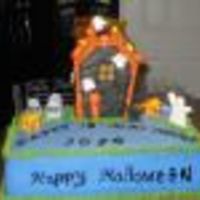 Hollow!! Marble cake with vanilla buttercream. Gumpaste ghost, royal icing fence and a gingerbread house in the center.