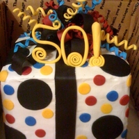 50Th Birthday Chocolate cake frosted in buttercream, fondant cut outs and bow with some gumpaste accents.