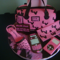 Louie Bag Cake yellow cake covered in pink and brown fondant, shoe is gumpaste and fondant and accessories are made out of chocolate using molds