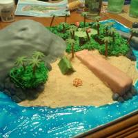 Lord Of The Flies Made by 16 year old son for a school project. With help from his Dad of course...... Main island is cake, fondant rocks. The two small...