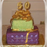 50Th Birthday Two packages cake covered in fondant, bottom is chocolate with chocolate/kahlua mousse and chocolate buttercream under the fondant, top one...