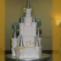 Cinderella's Castle 4 tiers of Almond cake with Pineapple filling. Towers made of pastillage, and then covered with fondant. Turrets are sugar cones covered...
