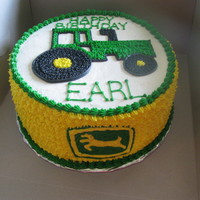 John Deere Cake This is just a layered round cake with a tractor freehanded and startipped on top and bigger star tips all around the side with the John...