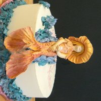 Mermaid With A Pearl Four year olds are into mermaids this year..don't ask me why. This one is made of gumpaste and I simply split the body and tooled it...