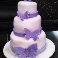 Mini Butterflies Its yellow cake with chocolate mousse and strawberries filling with buttercream as the crumb coat, covered in fondant and the purple...