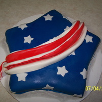 4Th Of July Star Fondand covered white butter cake with a red and white sash.