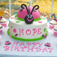 Ladybug Bash! 10" buttercream with half sports ball on top with fondant Lady Bug. All cupcake ladybugs made from candy clay and fondant.