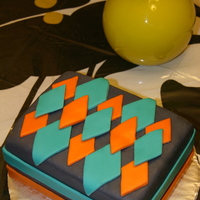 Argyle Sweater In A Box Chocolate Cake with Ganach frosting and filling covered in MMF.