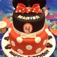 Minnie Mouse Cake Cakes covered in Fondant and decorated to match birthday girl's dress.
