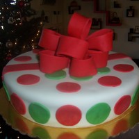 Christmas Package A "gift" cake I did.. everything fondant. Actually from this angle it looks like the cake is lopsided... kind of coming to a...