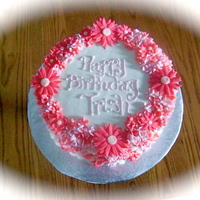 Daisies & Swirl Flowers 10 inch round cake, buttercream icing, basketweave. Daisies are made from fondant.