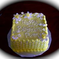 Yellow Birthday Cake 8 inch cake, buttercream icing, basketweave, shell border, flowers made from gumpaste/fondant