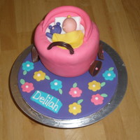 Baby In Stroller Cake vanilla cake, raspberry filling, buttercream, fondant, modeled figure