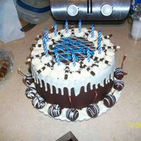Josh's Birhtday Cake Just a simple birthday cake. 1 layer of chocolate cake, 1 layer of white cake. raspberry and fudge fillings, cream cheese icing, enrobed in...