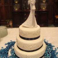Navy And Ivory Wedding Cake Three tier vanilla wedding cake covered in ivory fondant. The piping is homemade buttercream with silver dragee accents. The ribbon around...