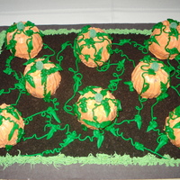 Pumpkin Patch This cake was alot of fun to make. Inverted 2 cupcakes to form the pumpkins, gum drops for the stems and crushed oreos for the dirt.
