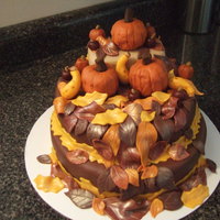 Fall Harvest Pumpkin are inverted cupcakes shaved to shape. Squash, apples, mini pumpkins and leaves are fondant.