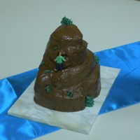 Rock Climbing Cake Chocolate cake, filled with caramel and topped with chocolate buttercream. Climber made of fondant.