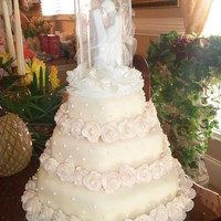 My Daughters Wedding Cake Ivory fondant with 80 fondant mini rose. I made my first wedding cake for someone very special to me..my daughter, so getting this right...