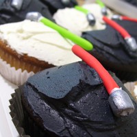 Light Saber Cupcakes I made these for a friends Son's birthday. The black cupcakes were the dark side and the white cupcakes are the gooood side!!! :)