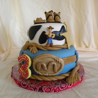 Cowboy Woody (Toy Story) Cake Chocolate cake with peanut butter buttercream, covered in MMF. Accents made with caramel and chocolate fondant. For a little boy's 3rd...