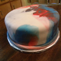 Patriotic Tie-Dyed Cake Vanilla/blue cake with raspberry buttercream and marshmallow fondant.