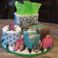 Girl's Shopping Spree Four seperate cakes: strawberry, chocolate, & vanilla. Purse is made of krispie treats. Shoes, make up, and jewelry are gumpaste.