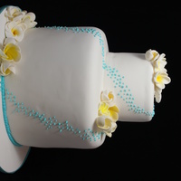 Frangiapani Wedding Cake Made this cake in very hot 40*C The fondant was literally melting and falling off the cake... took me 4 times of icing pulling off, and re...
